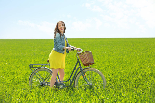 young woman with bicycle - Фото, зображення