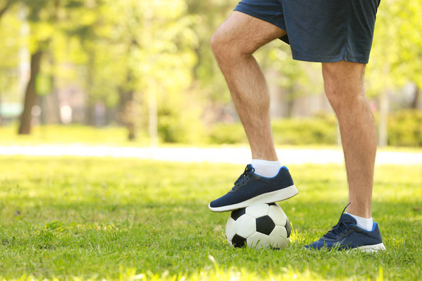 Legs of young man with soccer ball  - Фото, зображення