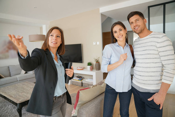 Couple with agent visiting house - Photo, image