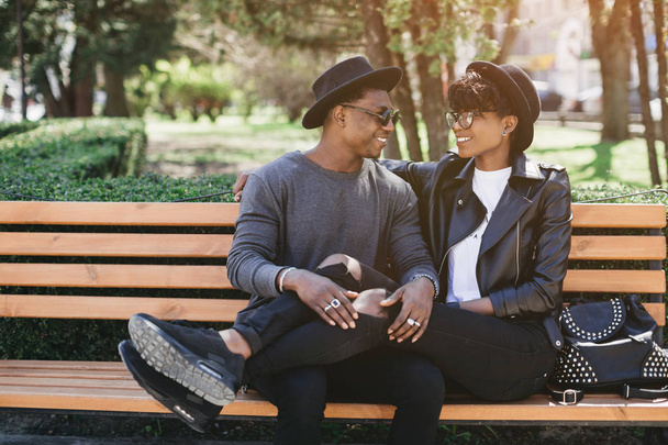 african couple on wooden bench - Photo, Image