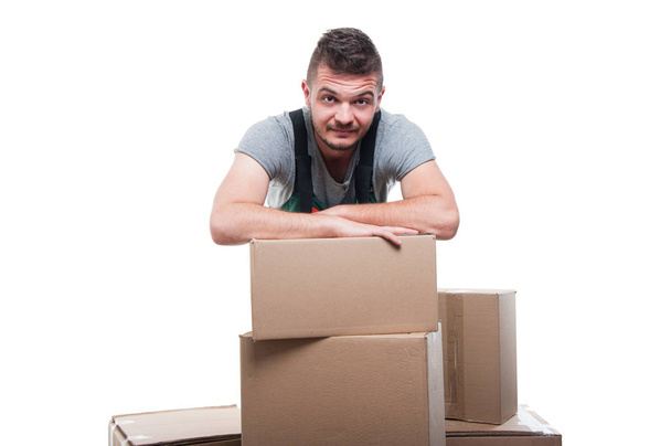 Portrait mover man posing behind cardboard boxes  - Foto, afbeelding