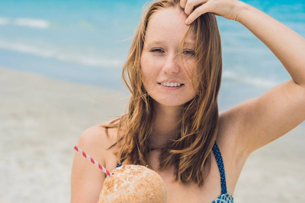 Young woman drinking coconut milk  - Фото, зображення