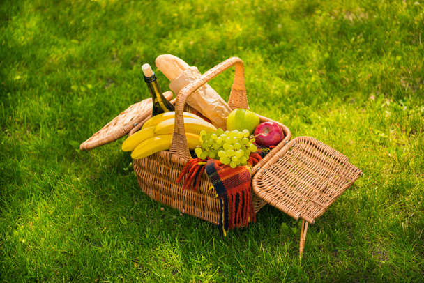 Picnic basket with fruits and wine  - Fotó, kép