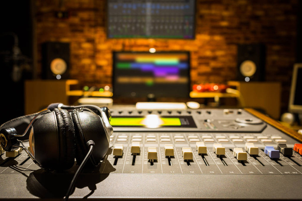 headphones on sound mixer in digital recording studio - Foto, Imagen