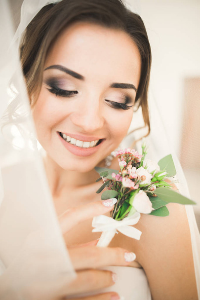 Portrait of beautiful bride with fashion veil at wedding morning. - Foto, imagen
