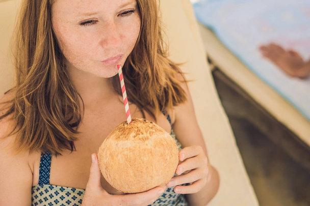 Young woman drinking coconut milk  - Foto, Imagem
