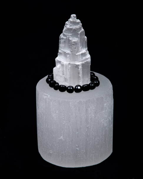 Selenite everest carving surrounded by black tourmaline bracelet - Photo, Image