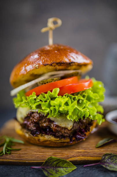 Tasty grilled beef burger with spinach lettuce and blue cheese s - Photo, Image