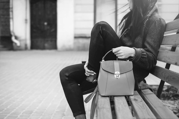Woman sitting on bench with bag - Fotografie, Obrázek