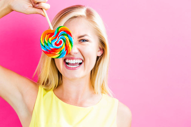 Young woman eating a lollipop - Foto, Imagem