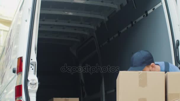 Strong Mover Loads His Van with Cardboard Boxes from the Street. - Filmmaterial, Video
