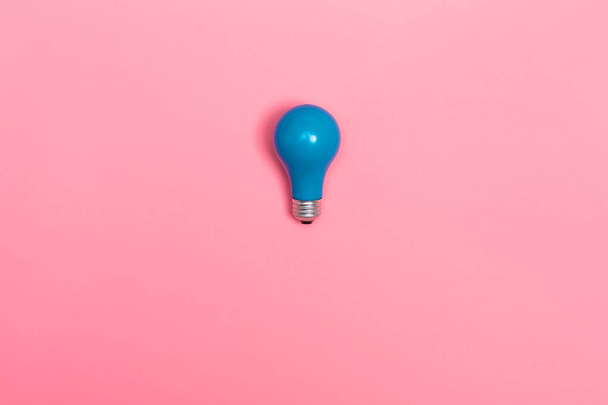 Blue light bulb on a vibrant background - 写真・画像