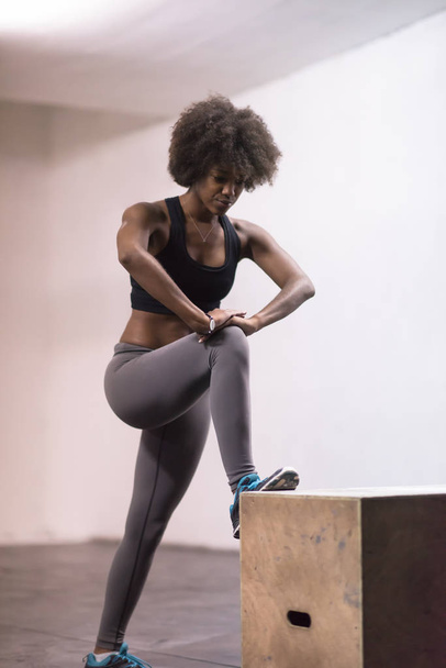 black woman is preparing for box jumps at gym - Photo, Image