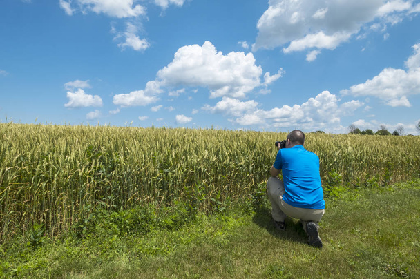 Photographer Making a Photo of a Wheat Field - Photo, Image
