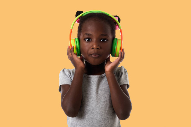 African lovely little girl with headphones. - Photo, Image