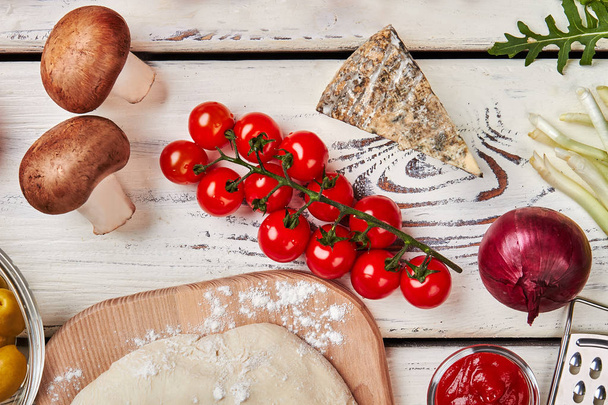 Mushrooms, dough, blue cheese, tomatoes. - Фото, изображение