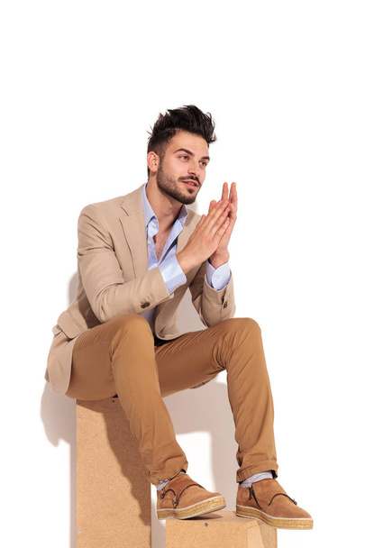 side view of a young businessman holding palms together  - Φωτογραφία, εικόνα