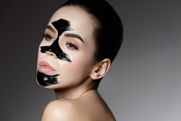 Beauty Cosmetics. Female With Black Skin Care Peel Mask On Face. - Zdjęcie, obraz