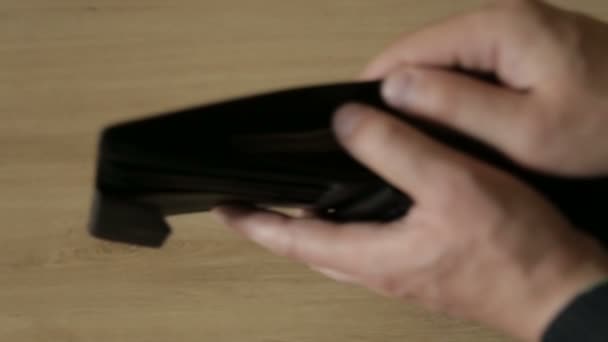 A man takes out banknotes from a leather purse - Footage, Video
