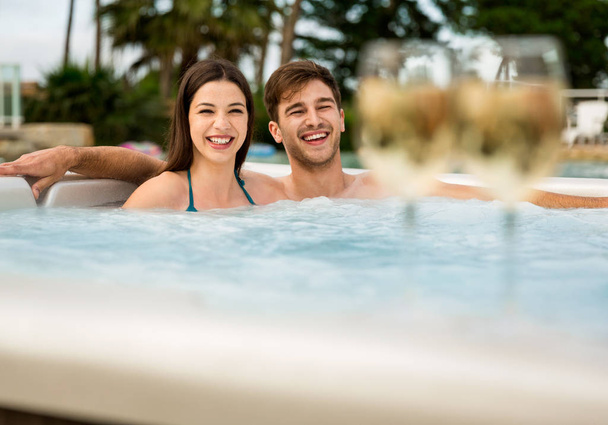 Young couple inside jacuzzi  - Foto, afbeelding