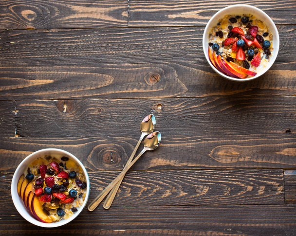 Healthy breakfast with milk,muesli and fruit, on a wooden backgr - 写真・画像