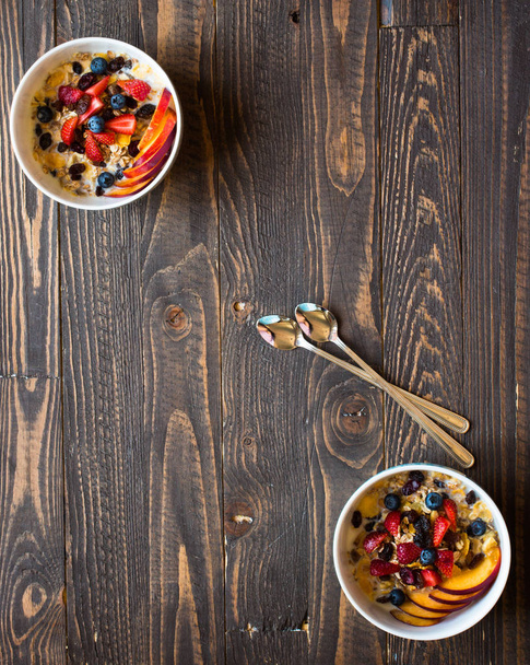 Healthy breakfast with milk,muesli and fruit, on a wooden backgr - 写真・画像