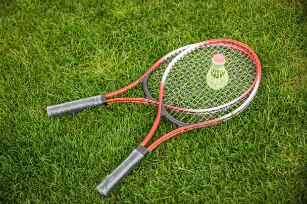 Badminton racquets and shuttlecock   - Фото, зображення