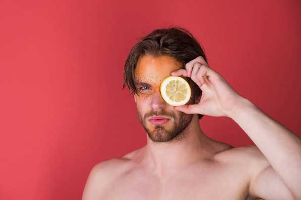 handsome man with creative fashionable makeup hold lemon, vitamin - Foto, immagini