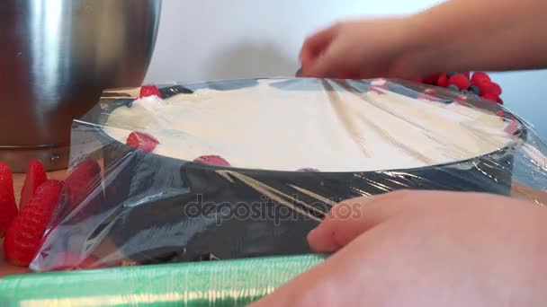 Uma mulher envolve um bolo em uma forma
 - Filmagem, Vídeo