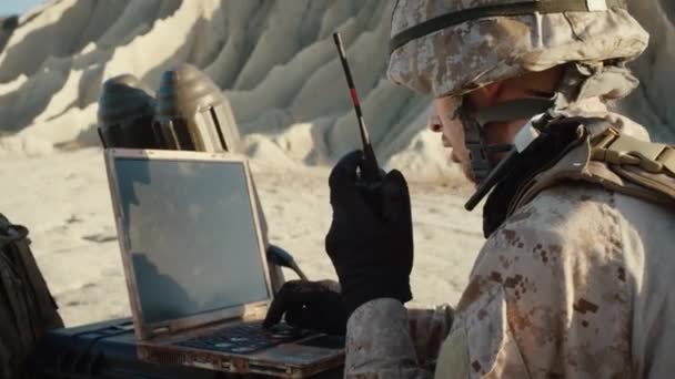 Soldiers are Using Laptop Computer and Radio for Communication During Military Operation in the Desert - Filmagem, Vídeo