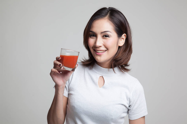 Young Asian woman drink tomato juice. - Zdjęcie, obraz