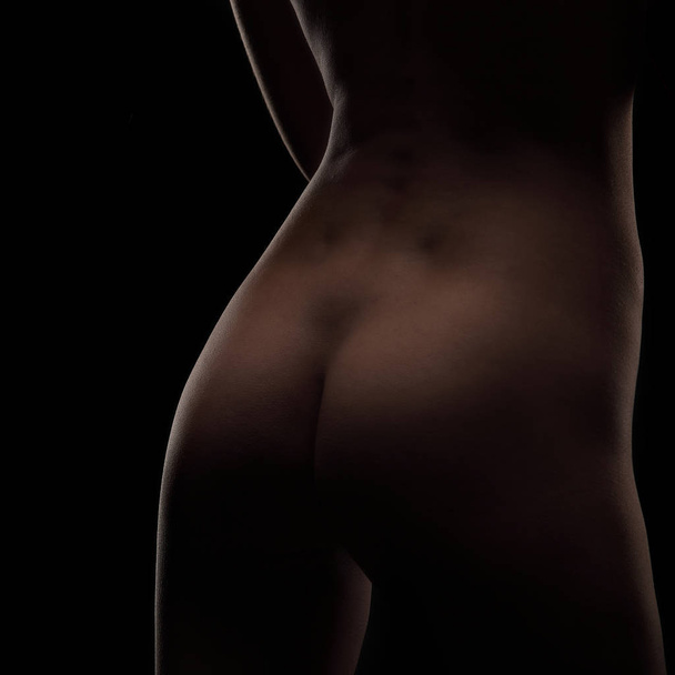 Sexy nude woman body over black studio background, closeup ass profile - Fotoğraf, Görsel