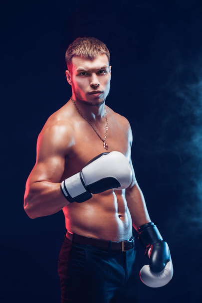 Aggressive shirtless boxer on grey background. - Foto, imagen