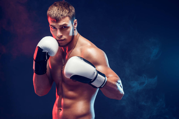 Aggressive shirtless boxer on grey background. - Фото, изображение