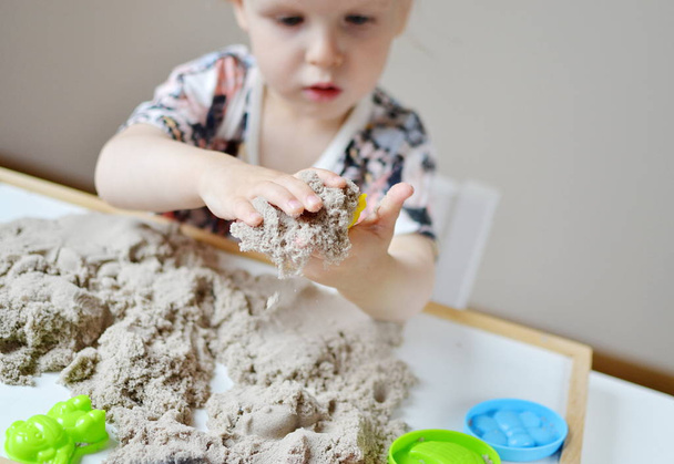 Girl playing with kinetic sand  - Photo, Image