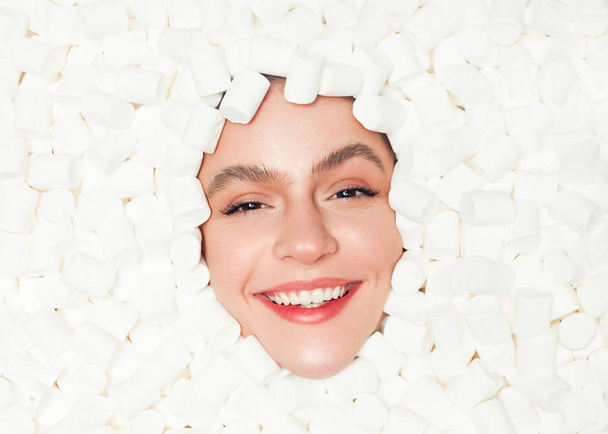 Content model posing in fluffy marshmallows - Zdjęcie, obraz
