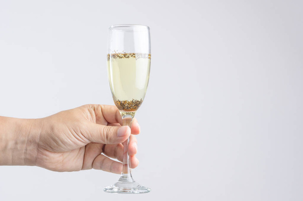 Hand holding glass of champagne with pest or insect - Zdjęcie, obraz