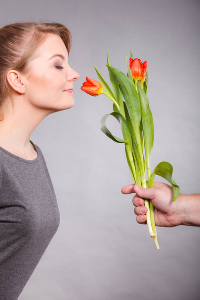 Charming woman smelling flower feel peace. - Foto, afbeelding