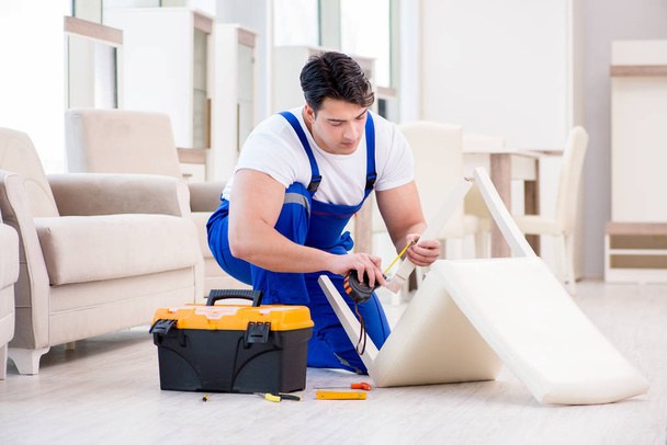 Furniture repairman working in store - Foto, Bild