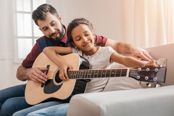 Family playing guitar  - Photo, Image