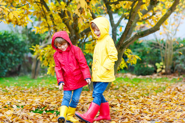 Two little best friends and kids boys autumn park in colorful clothes. - Photo, Image