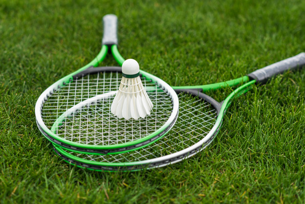 Shuttlecock on badminton rackets  - Фото, изображение
