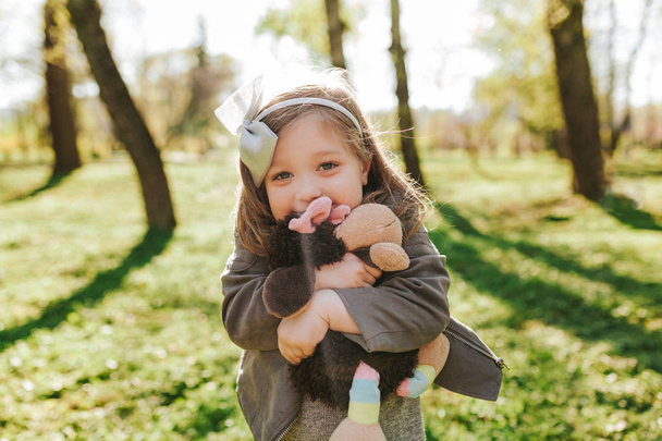 Charming little girl posing with toy - Fotó, kép