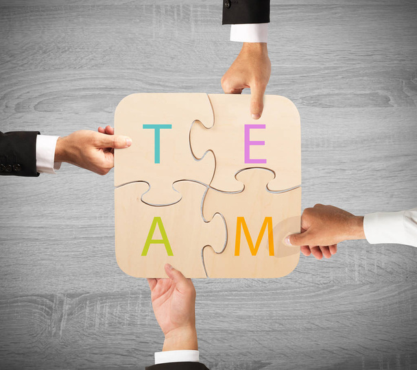 team  working  together with puzzle - Foto, Bild