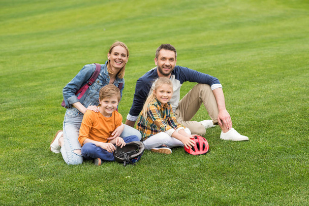 family sitting on grass - Photo, Image