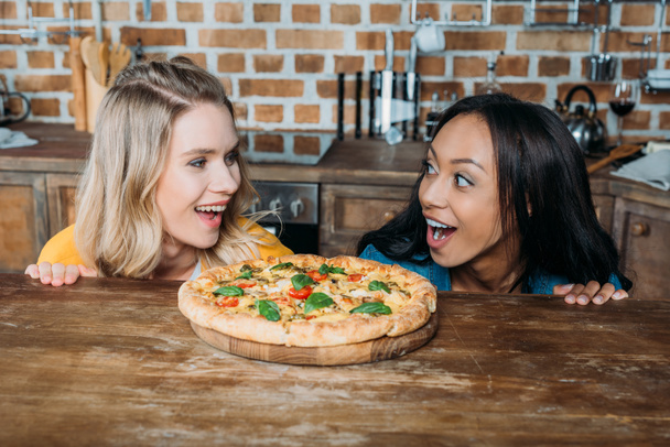 Multiethnic women with pizza  - Photo, image