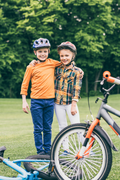 children with bicycles at park - Photo, Image