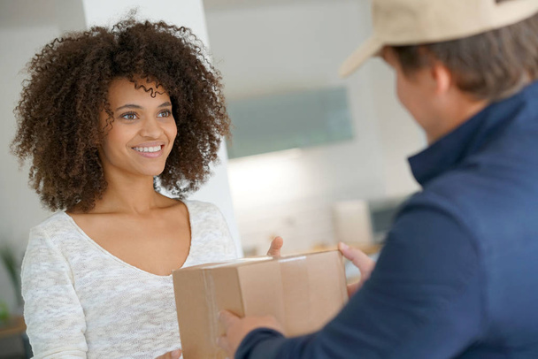 woman receiving package from delivery man - Photo, Image
