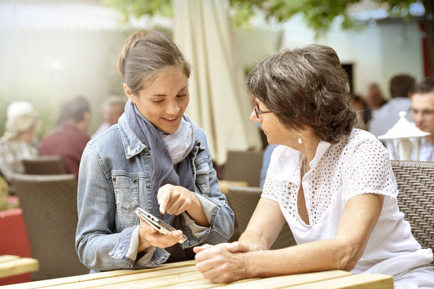 Woman and  carer using smartphone - Photo, image