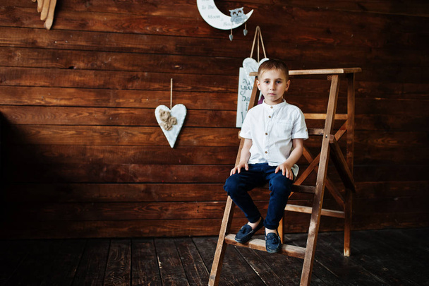 Portrait of a small handsome boy in official clothes posing on t - Valokuva, kuva